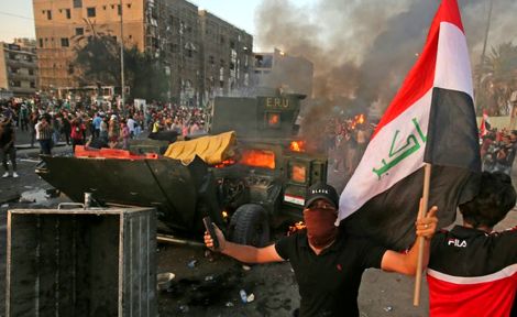 افزایش تلفات اعتراضات عراق به ۱۰۰ نفر + عکس